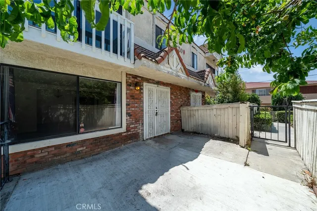 a view of a house with a sink and wooden fence
