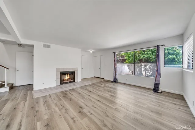 wooden floor fireplace and natural light in room