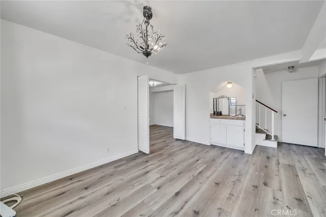 a view of a room with wooden floor and staircase