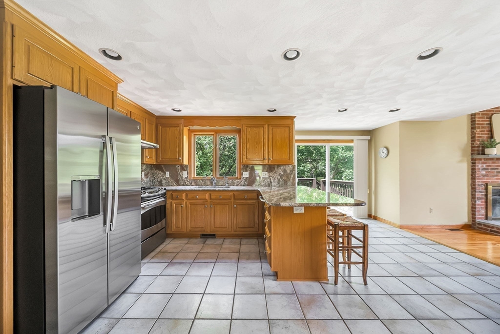 83 Jefferson Road Franklin, MA 02038 - Photo 6 of 34 a kitchen with granite countertop a refrigerator and a sink