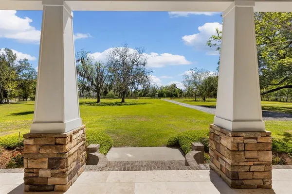 a pathway of a house with a yard
