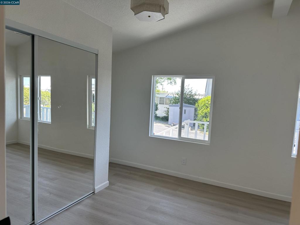 60 Wilson Way Milpitas, CA 95035 - Photo 13 of 22 a view of an empty room with wooden floor and a window