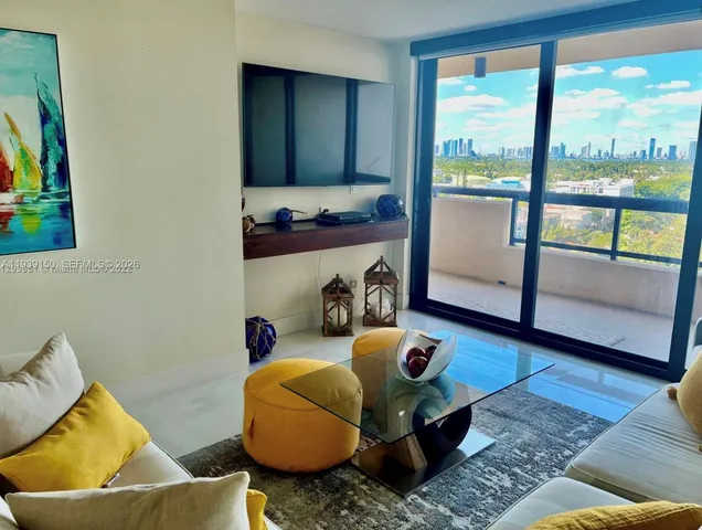 a kitchen with stainless steel appliances granite countertop a sink a stove a microwave a refrigerator and cabinets