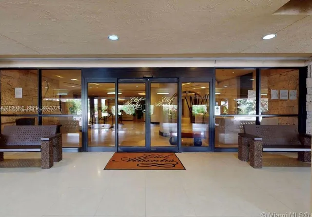 a swimming pool with outdoor seating and lots of palm trees