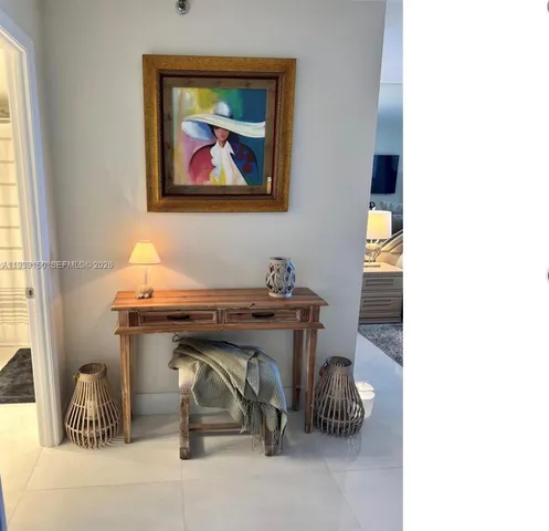 a spacious bedroom with a bed and wooden floor