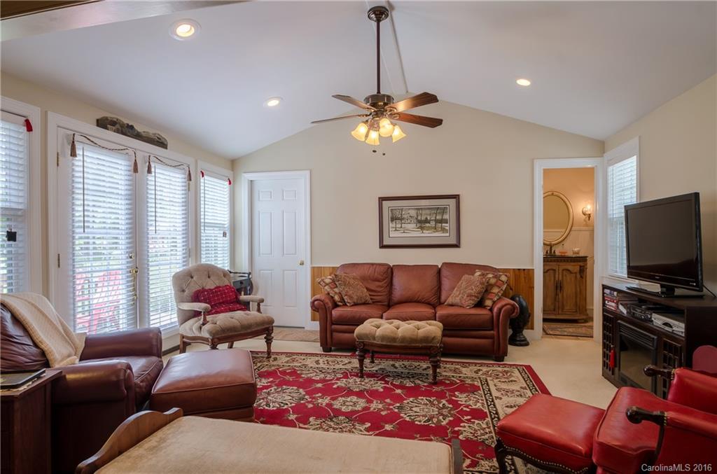 427 Fieldstone Road Mooresville, NC 28115 - Photo 8 of 17 a living room with furniture a flat screen tv and a large window