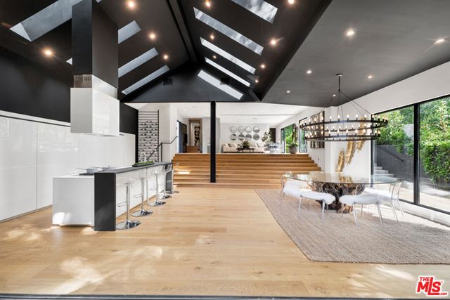 a room with lots of wooden furniture and a chandelier