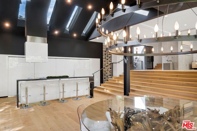 a view of kitchen with dining area and chandelier
