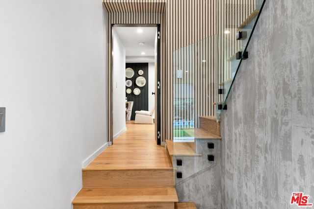 a view of entryway and hall with wooden floor