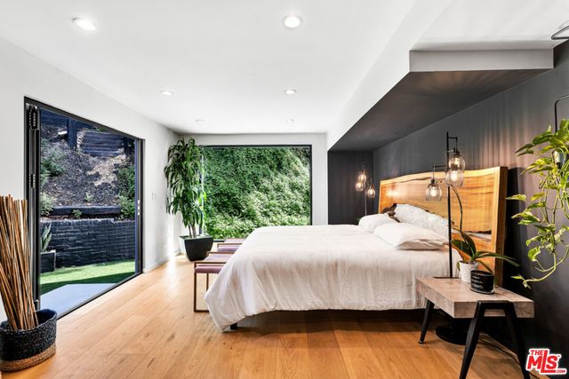 a bedroom with a large bed and a large window