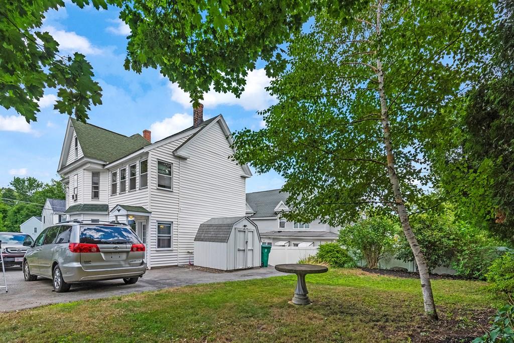 143 18th Street Lowell, MA 01850 - Photo 11 of 35 a white house that has a tree in front of it