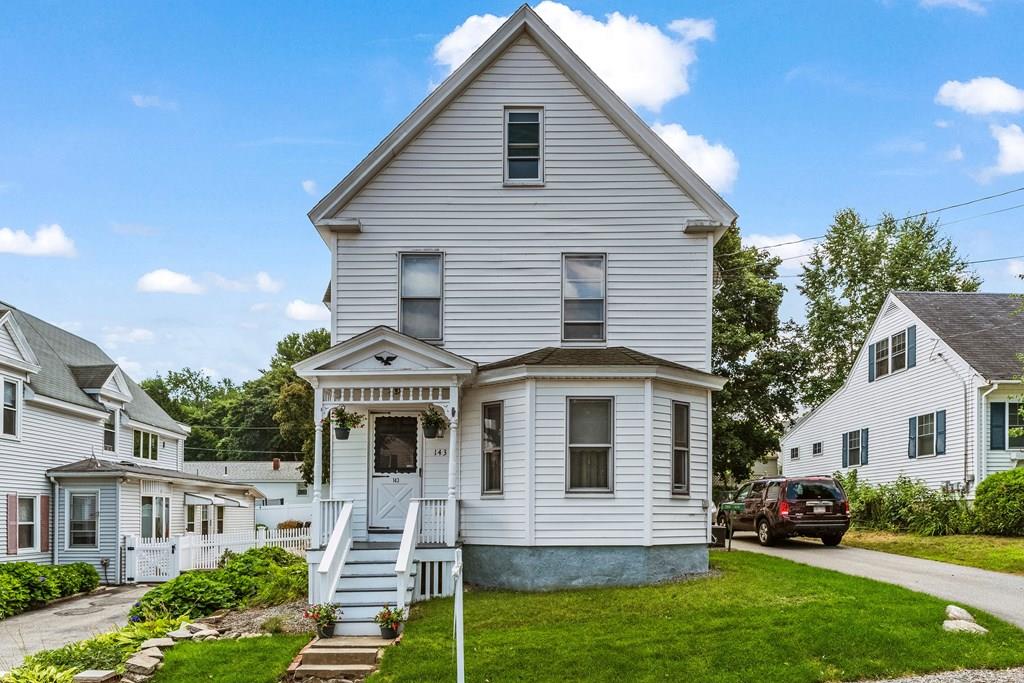 143 18th Street Lowell, MA 01850 - Photo 2 of 35 a front view of a house with a yard