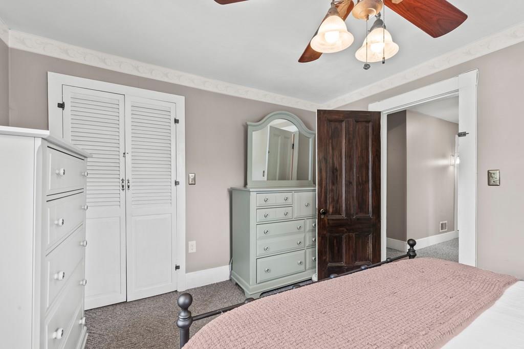143 18th Street Lowell, MA 01850 - Photo 25 of 35 a bedroom with a bed and a chandelier