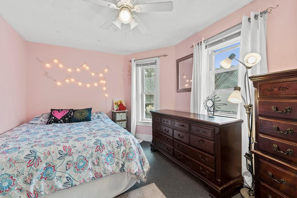143 18th Street Lowell, MA 01850 - Photo 27 of 35 a bedroom with a bed and wooden floor