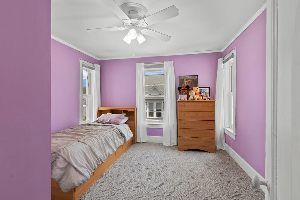 143 18th Street Lowell, MA 01850 - Photo 28 of 35 a bedroom with a bed and a dresser