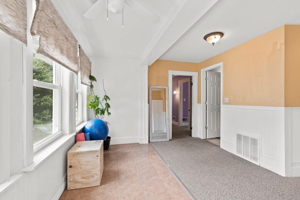 143 18th Street Lowell, MA 01850 - Photo 30 of 35 a view of an entryway with wooden floor and windows