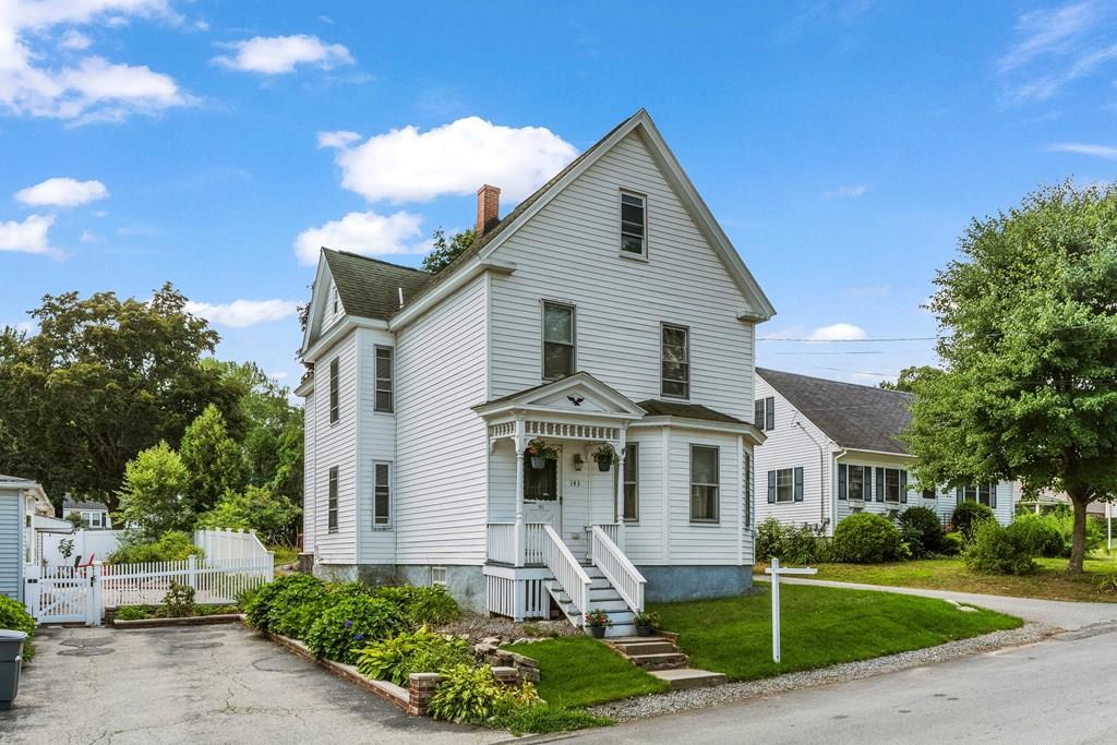 143 18th Street Lowell, MA 01850 - Photo 3 of 35 a front view of a house with garden