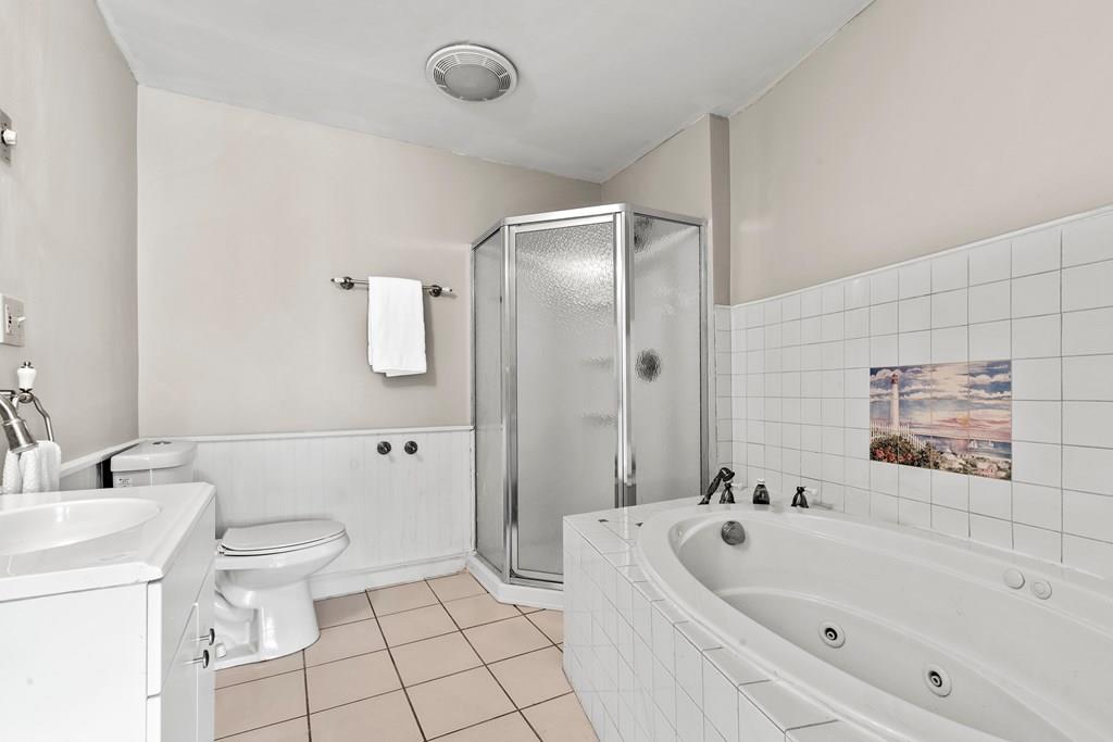 143 18th Street Lowell, MA 01850 - Photo 31 of 35 a bathroom with a bathtub toilet and sink