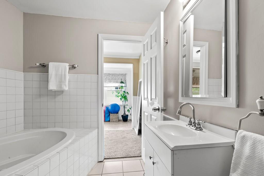 143 18th Street Lowell, MA 01850 - Photo 32 of 35 a bathroom with a tub sink and mirror