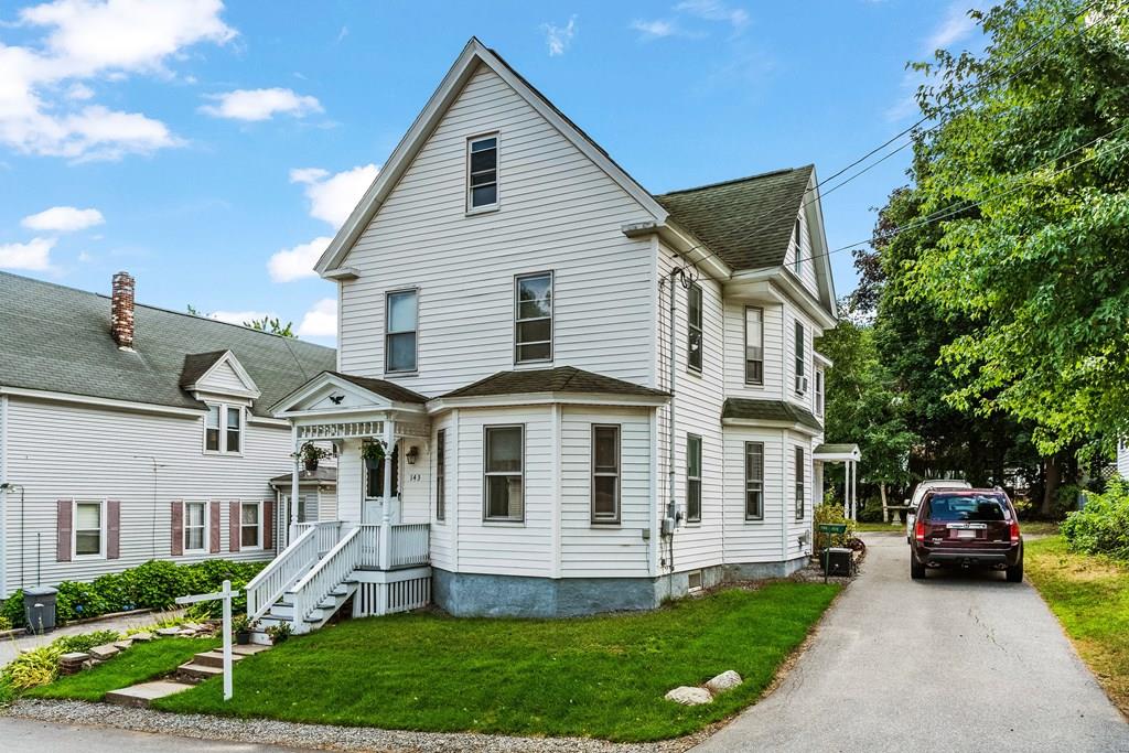 143 18th Street Lowell, MA 01850 - Photo 4 of 35 a front view of a house with a yard