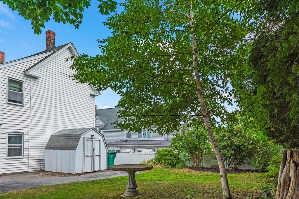 143 18th Street Lowell, MA 01850 - Photo 8 of 35 a front view of a house with garden