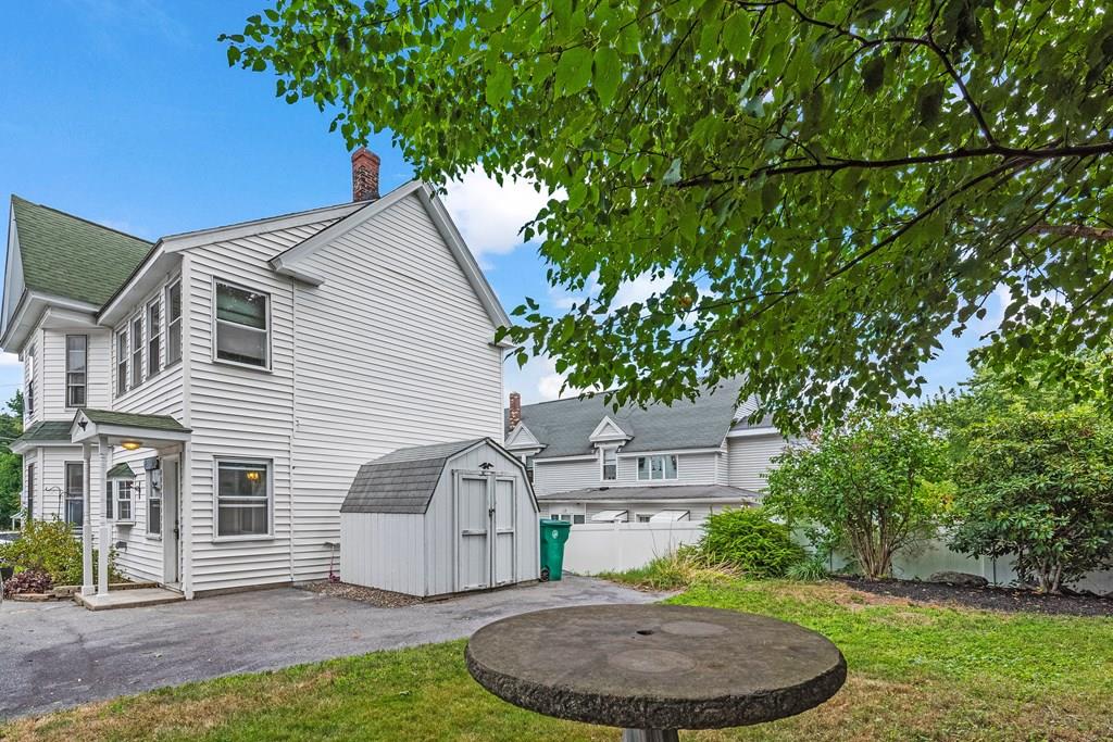 143 18th Street Lowell, MA 01850 - Photo 10 of 35 a view of a backyard with plants and a patio