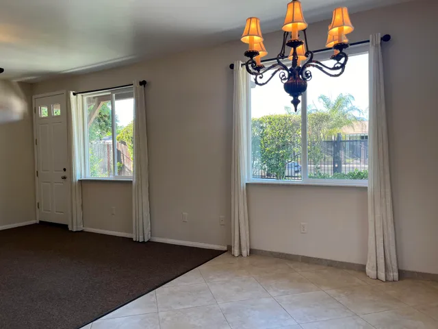 a kitchen with granite countertop a stove sink and refrigerator