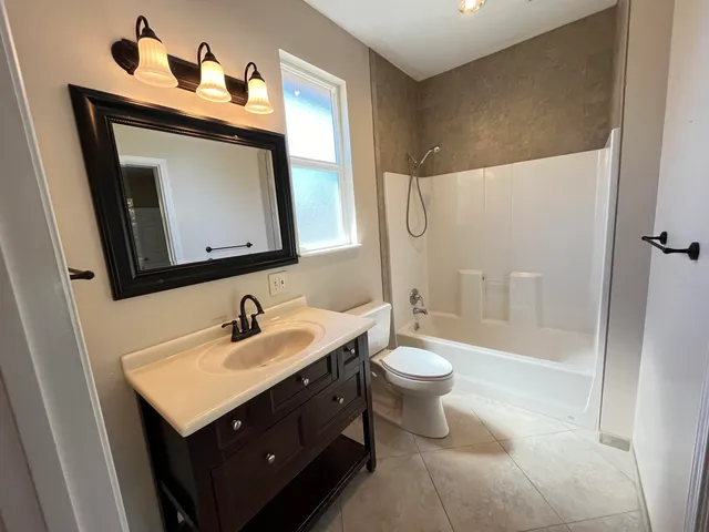 a view of a livingroom with a ceiling fan and window