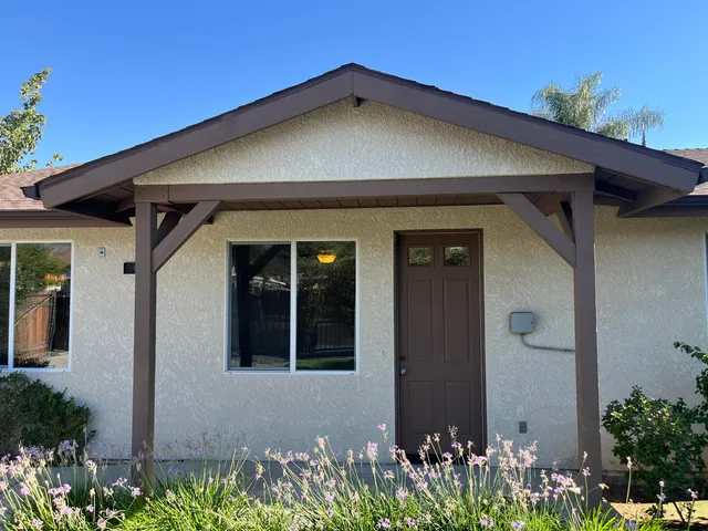 a view of a house with potted plants