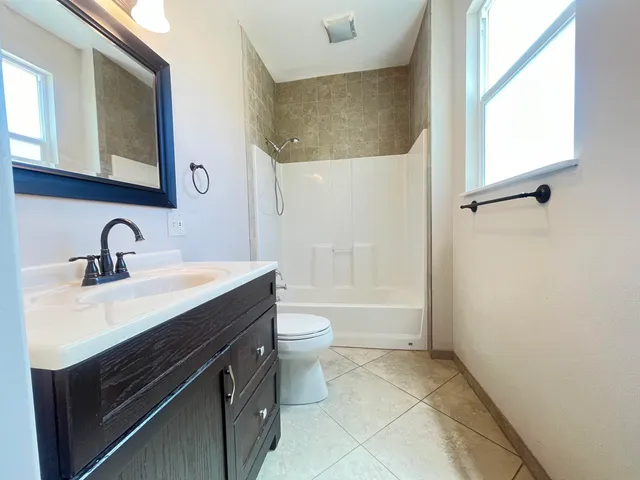 a view of a livingroom with a ceiling fan and window