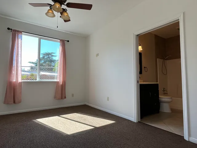 a bathroom with a granite countertop sink toilet a mirror and shower