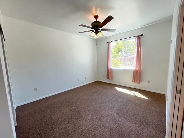 a kitchen with granite countertop a refrigerator and a sink