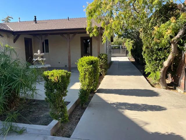 a view of a house with potted plants