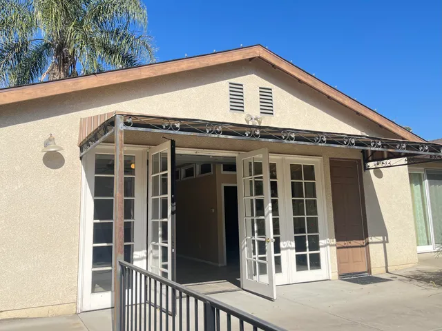 a view of a house with wooden fence