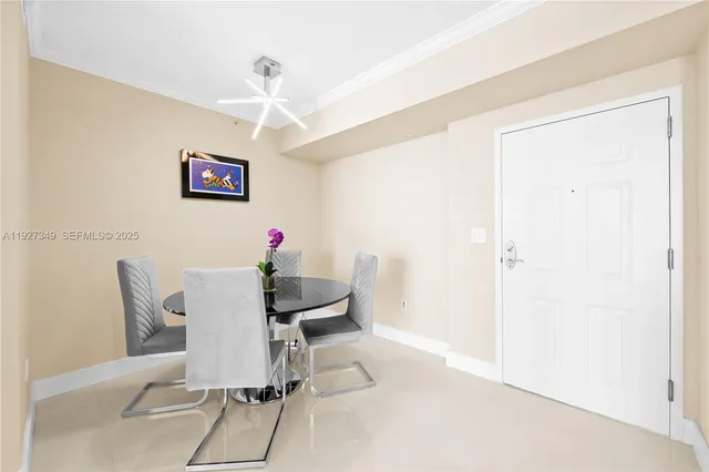 a view of a dining room with furniture and a chandelier
