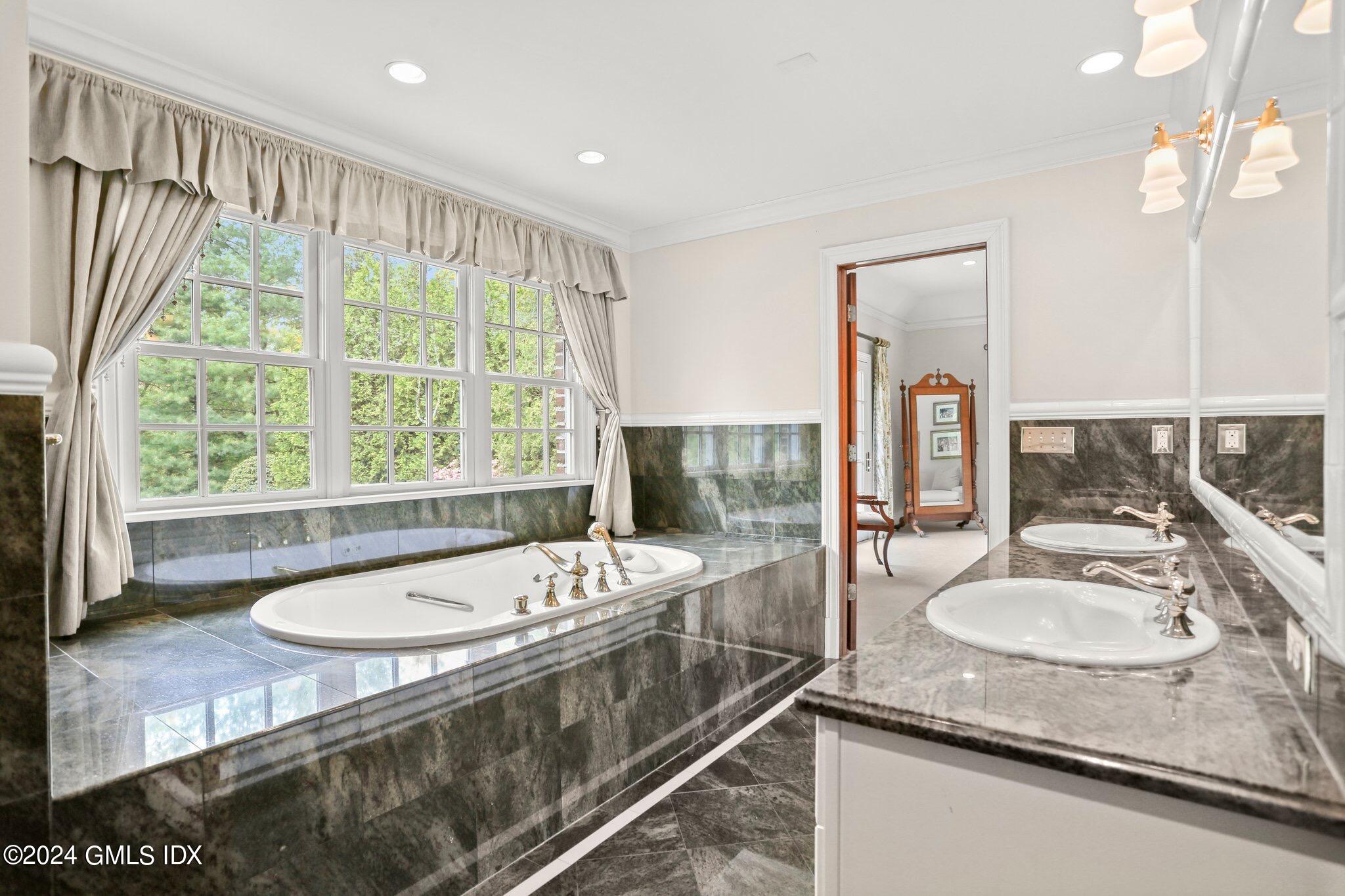 376 Westover Road Stamford, CT 06902 - Photo 24 of 37 a bathroom with a granite countertop tub sink and mirror