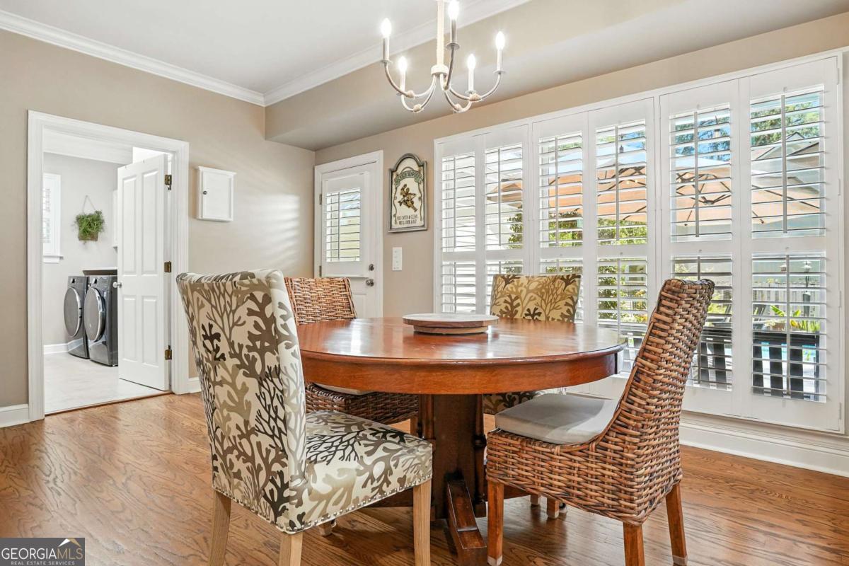 202 Vassar Point Drive St. Simons, GA 31522 - Photo 11 of 62 a view of a dining room with furniture window and wooden floor