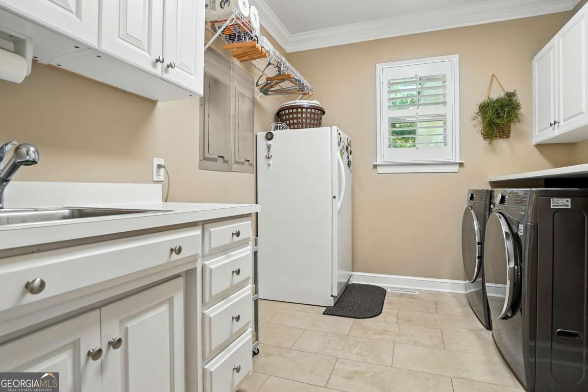 202 Vassar Point Drive St. Simons, GA 31522 - Photo 15 of 62 a kitchen with a refrigerator and a stove top oven