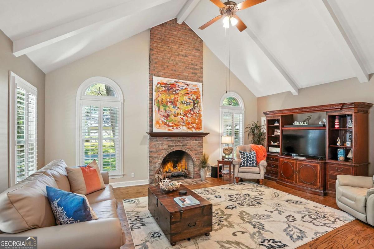 202 Vassar Point Drive St. Simons, GA 31522 - Photo 16 of 62 a living room with furniture a fireplace and a flat screen tv