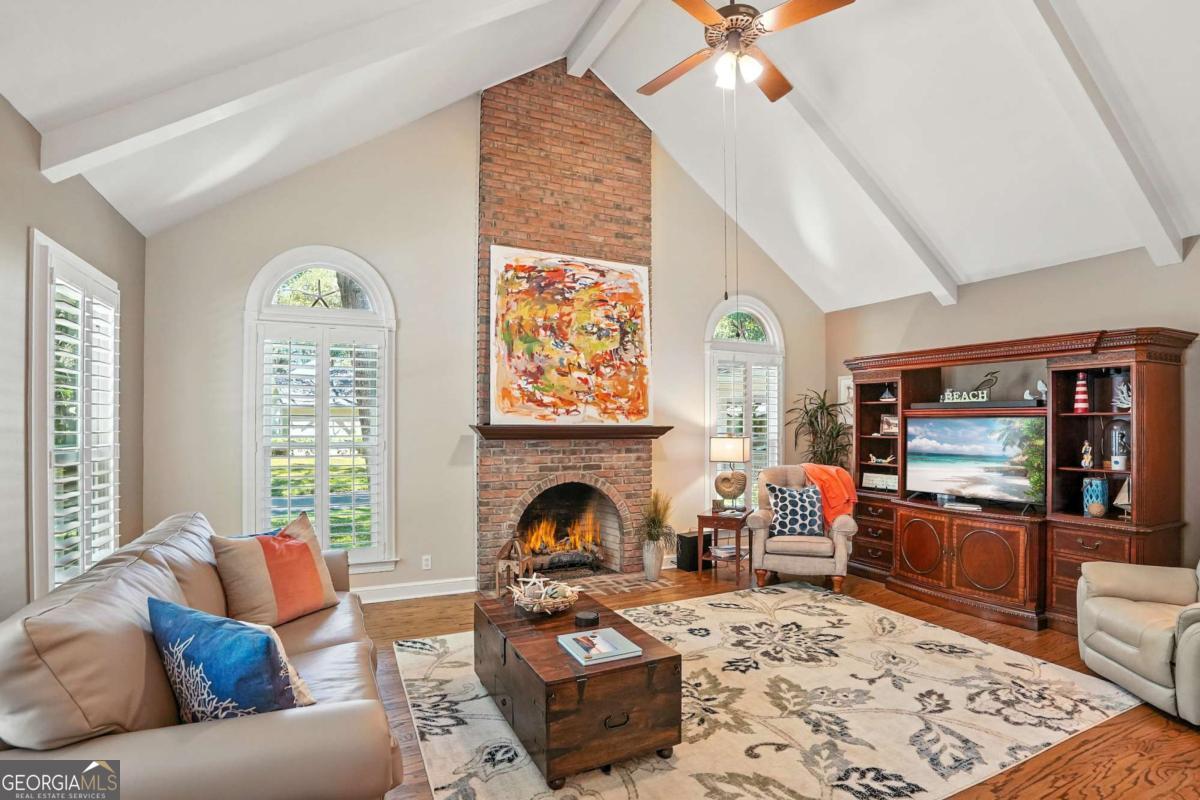 202 Vassar Point Drive St. Simons, GA 31522 - Photo 17 of 62 a living room with furniture a fireplace and a flat screen tv