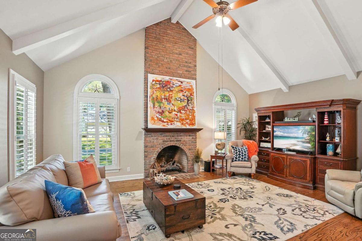 202 Vassar Point Drive St. Simons, GA 31522 - Photo 18 of 62 a living room with furniture a fireplace and a flat screen tv