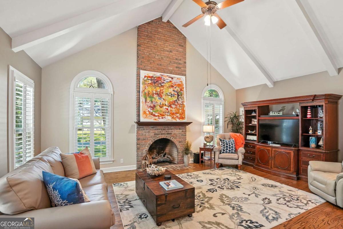 202 Vassar Point Drive St. Simons, GA 31522 - Photo 19 of 62 a living room with furniture a fireplace and a flat screen tv
