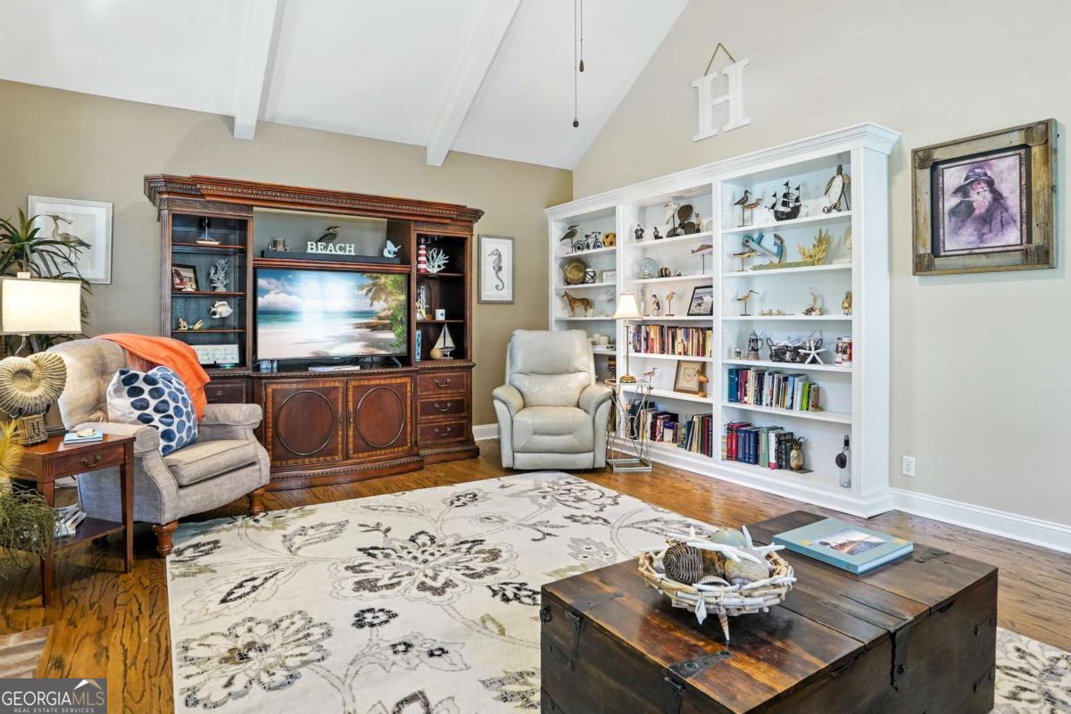 202 Vassar Point Drive St. Simons, GA 31522 - Photo 20 of 62 a living room with furniture and a flat screen tv