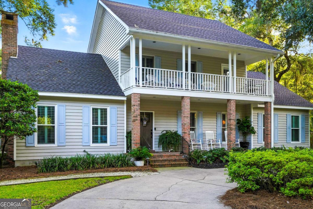 202 Vassar Point Drive St. Simons, GA 31522 - Photo 2 of 62 a front view of a house with garden