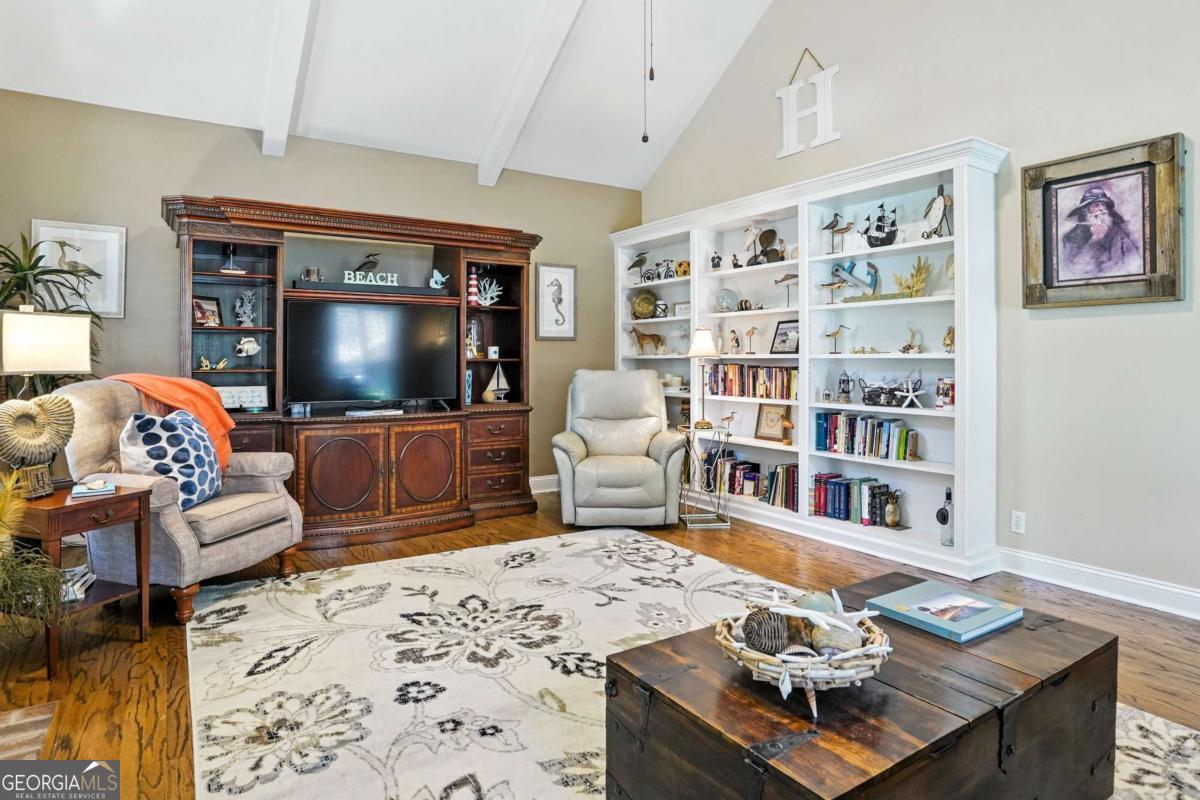 202 Vassar Point Drive St. Simons, GA 31522 - Photo 21 of 62 a living room with furniture and a flat screen tv