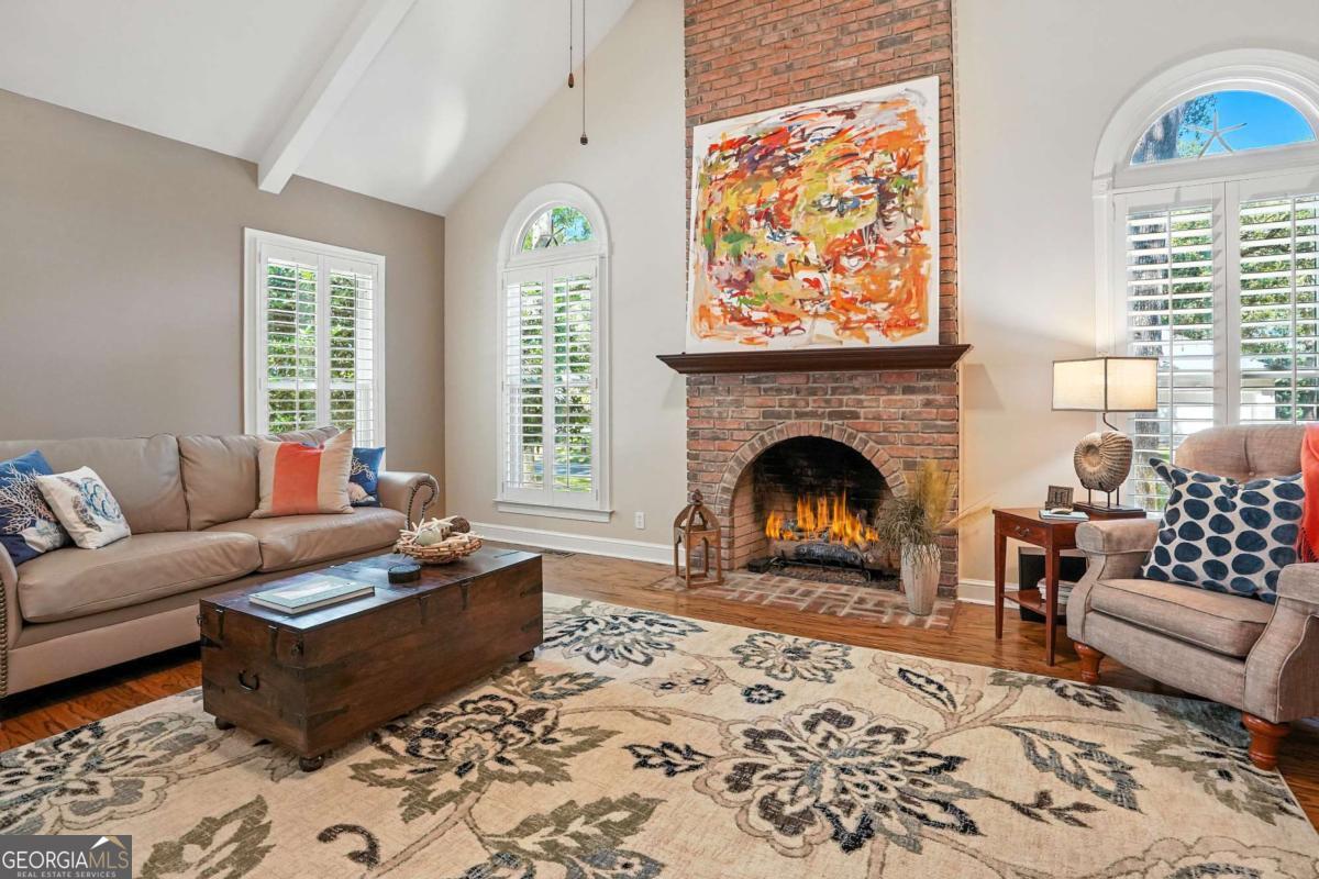 202 Vassar Point Drive St. Simons, GA 31522 - Photo 22 of 62 a living room with furniture a rug and a fireplace