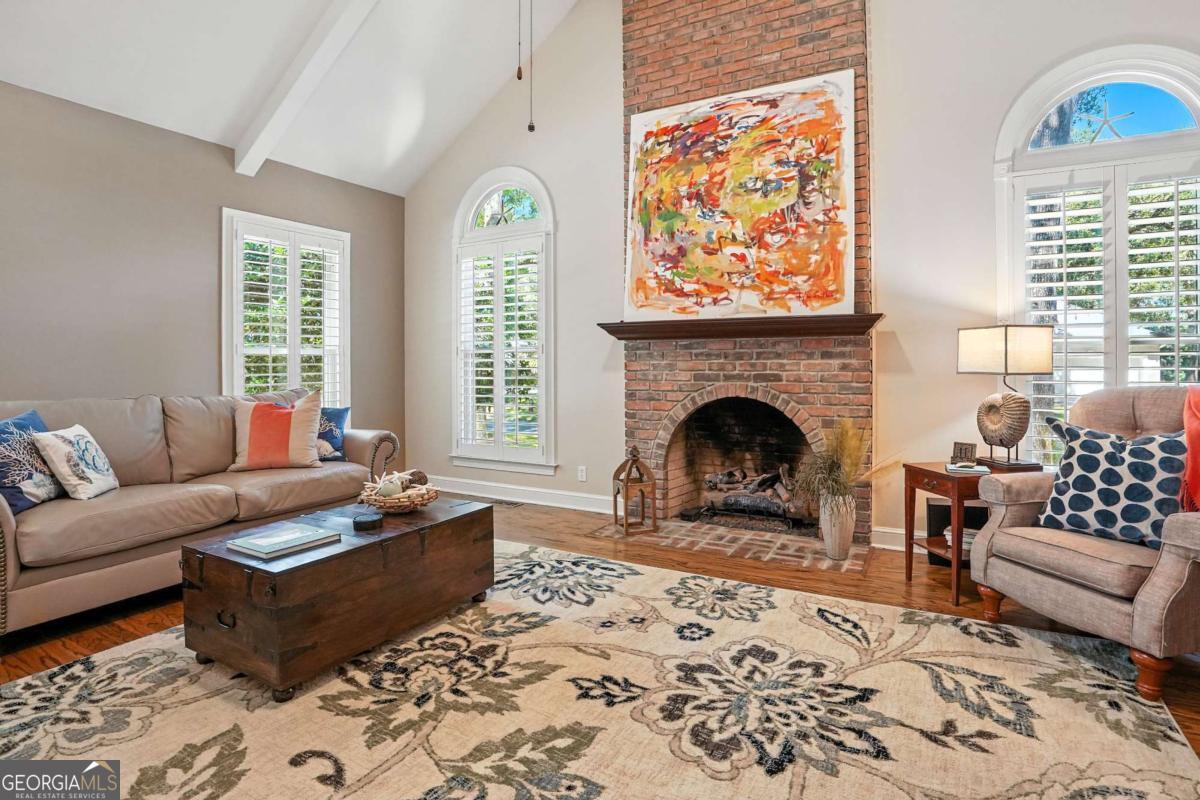 202 Vassar Point Drive St. Simons, GA 31522 - Photo 23 of 62 a living room with furniture a rug and a fireplace