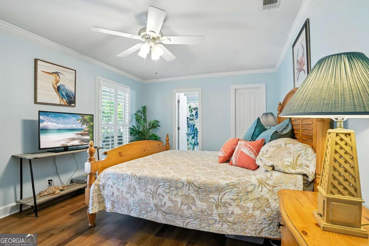 202 Vassar Point Drive St. Simons, GA 31522 - Photo 25 of 62 a bedroom with a bed and a flat screen tv