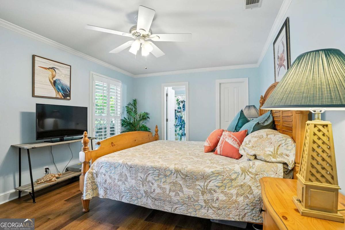 202 Vassar Point Drive St. Simons, GA 31522 - Photo 26 of 62 a bedroom with a bed and a flat screen tv