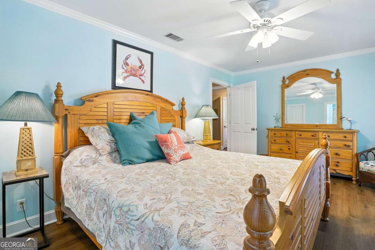 202 Vassar Point Drive St. Simons, GA 31522 - Photo 28 of 62 a bedroom with a bed and wooden floor